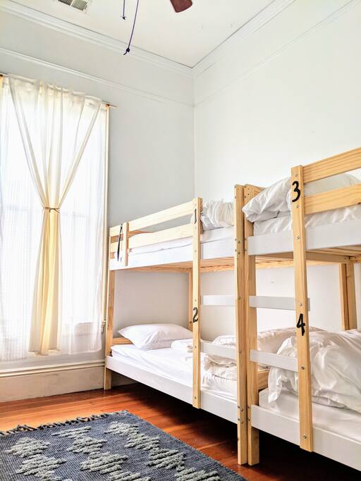 This large room has everything you need for a super comfy stay! Memory foam mattresses, towels, free slippers, ear plugs, lights beside each bed, outlets and USB plugs beside each bed, lockers with locks included, and more. :)