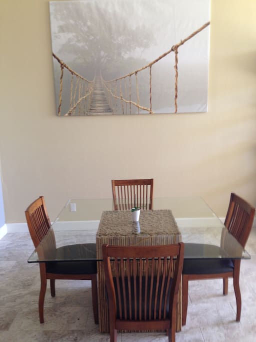 53" square glass dining table with 4 dining chairs provides ample space for family game night or simply group dining.