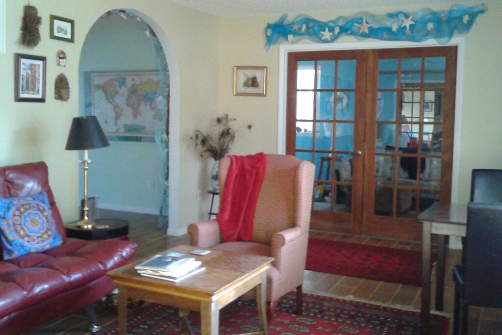 Living room with a small work area at the front window.