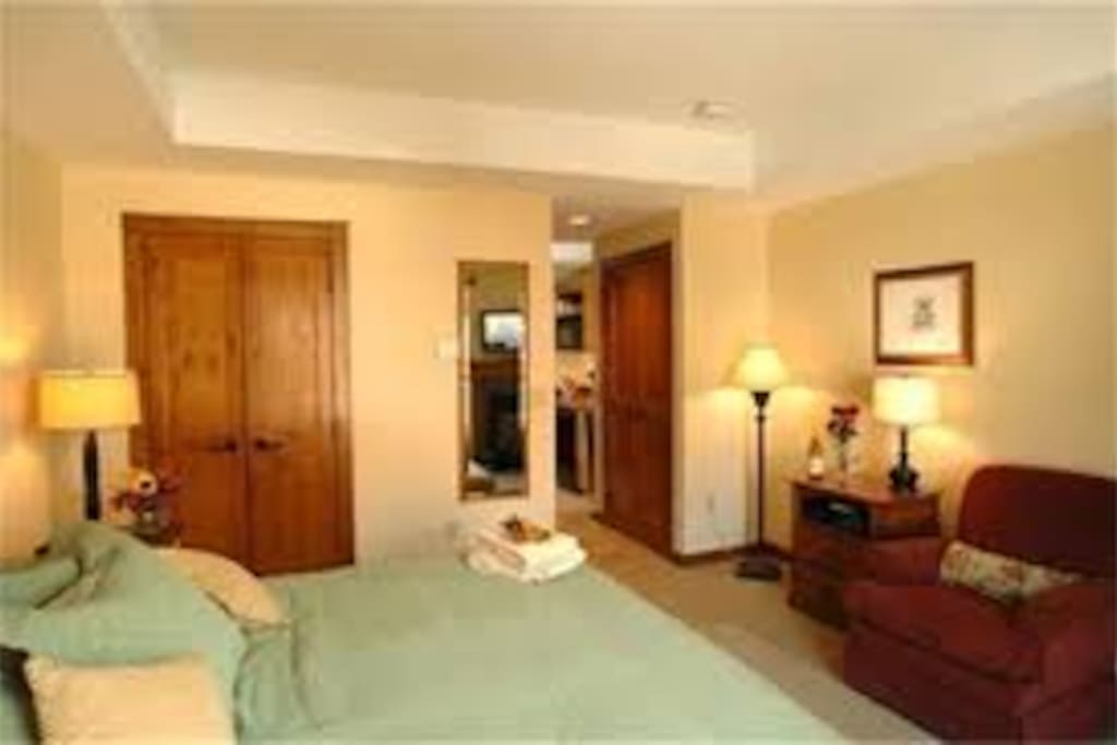 Closet space, king bed, flat screen TV with cable just outside frame, but its here! Views from bedroom are over the courtyard