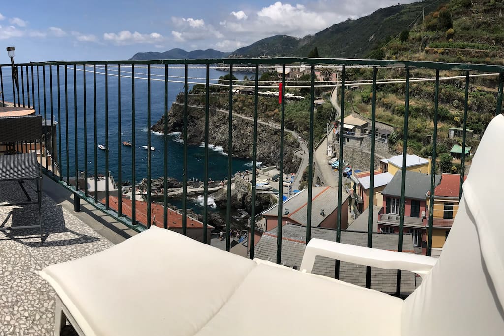 Panorama from the terrace. terrace furniture, comfortable deckchairs for sunbathing or relaxing to the sound of the sea. small table with two chairs suitable for breakfast, lunch and dinner on the sea.