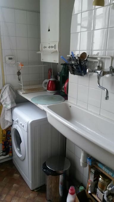 Vintage kitchen lay out (check out the sink!) but modern washing machine, water heater, gas stove, oven