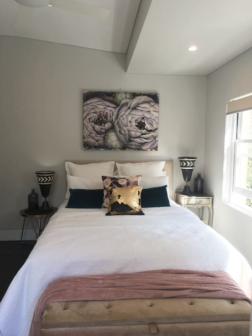 Queen bed in light filled space