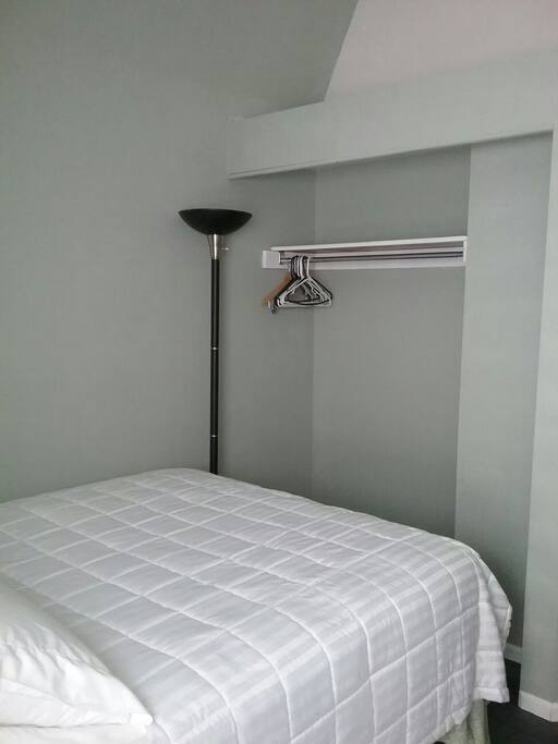 Empty closet with hangers and one shelf