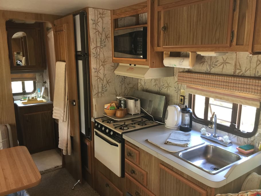 Fully stocked Kitchenette with fridge stove and sink, pots pans, dishes etc.