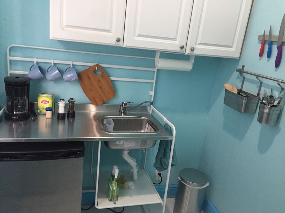 Kitchenette with mini fridge stocked with 6 mini waters, coffee, tea, sugar and creamer. Basic cooking utensils with 2 burner hot plate.