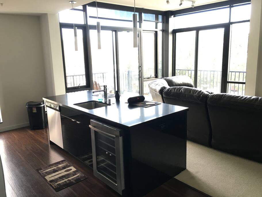 Kitchen and living room with floor to ceiling windows for a great view.