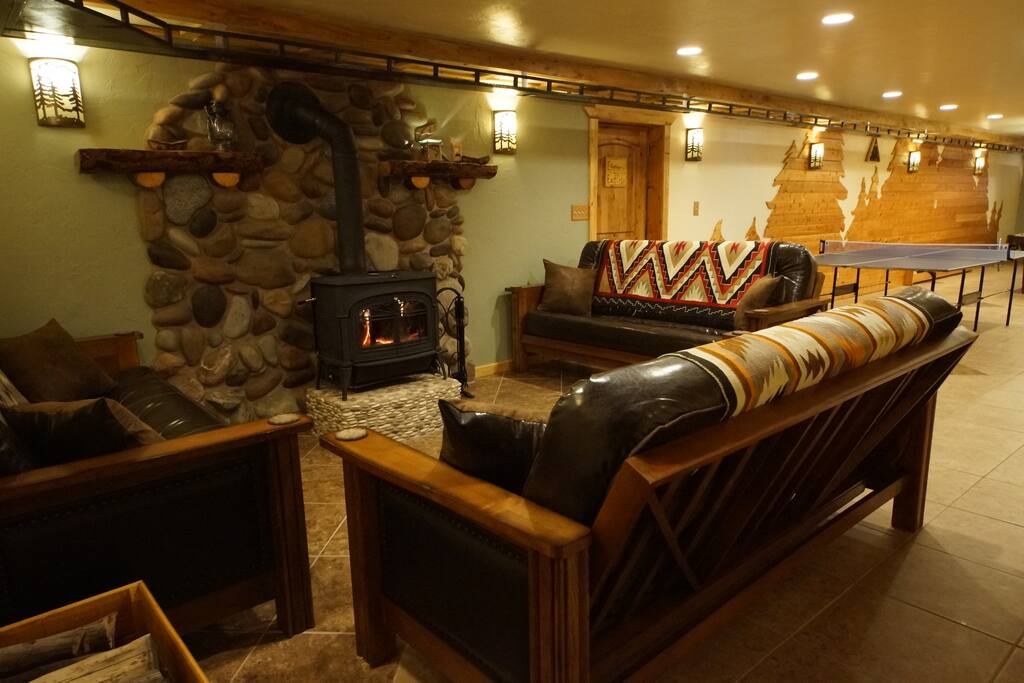 Game Room lounge area @ the Indian Ridge Lodge is a great place to hang out.
<!-- Check out these reviews!!! -->
"We had a 3-day family reunion last weekend at Indian Ridge Lodge and it turned out great!
There was plenty of room for everyone to sleep and the accommodations were very clean. Breakfast is included and it was outstanding both mornings! (Homemade scones, homemade muffins, ham, sausage, eggs, fruit, homemade jams, milk, juice, homemade granola, etc.) You certainly won't go away hungry...
The game room downstairs was a favorite place for many of the family to hang out but there is also plenty of room upstairs to visit, play card games, etc.
The family who runs the lodge is super nice, accommodating and helpful. You couldn't ask to meet nicer people.
I would HIGHLY recommend Indian Ridge Lodge!"
<!-- Please notice that some breakfast items are seasonal or in limited supply; contact us before your booking with any special requests.-->