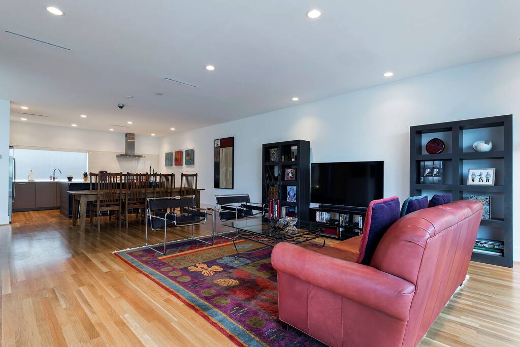 The living room is adjacent to the kitchen, where a bar seats three.