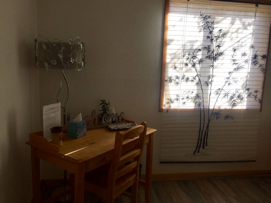 Writing desk by sunny window.