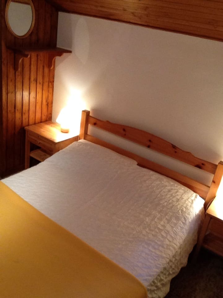 Acogedor dormitorio doble bajo los aleros.