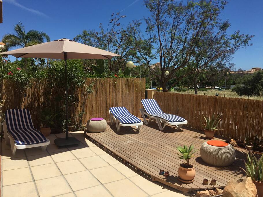 There are four sun loungers and some cool stools dotted around outside.
