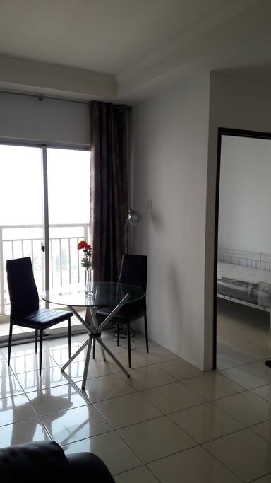 Dining table by the balcony. Bedroom2: Single bed.