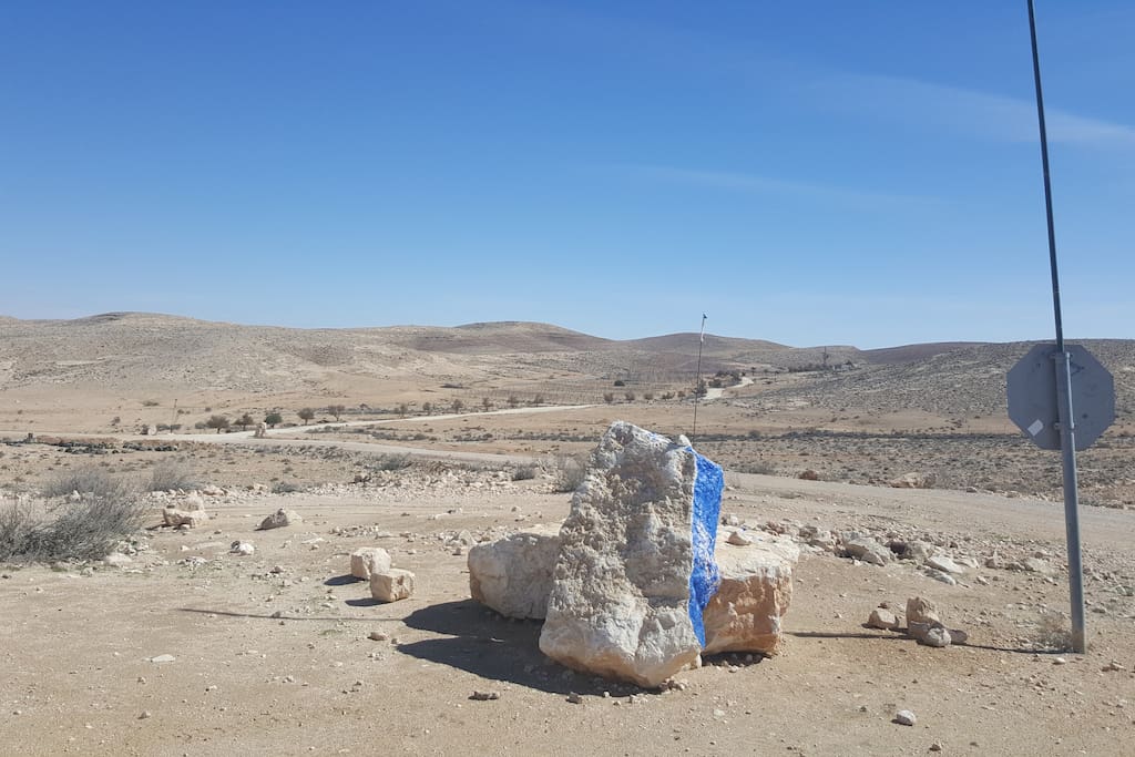 The rock painted blue indicating the entrance of the farm.