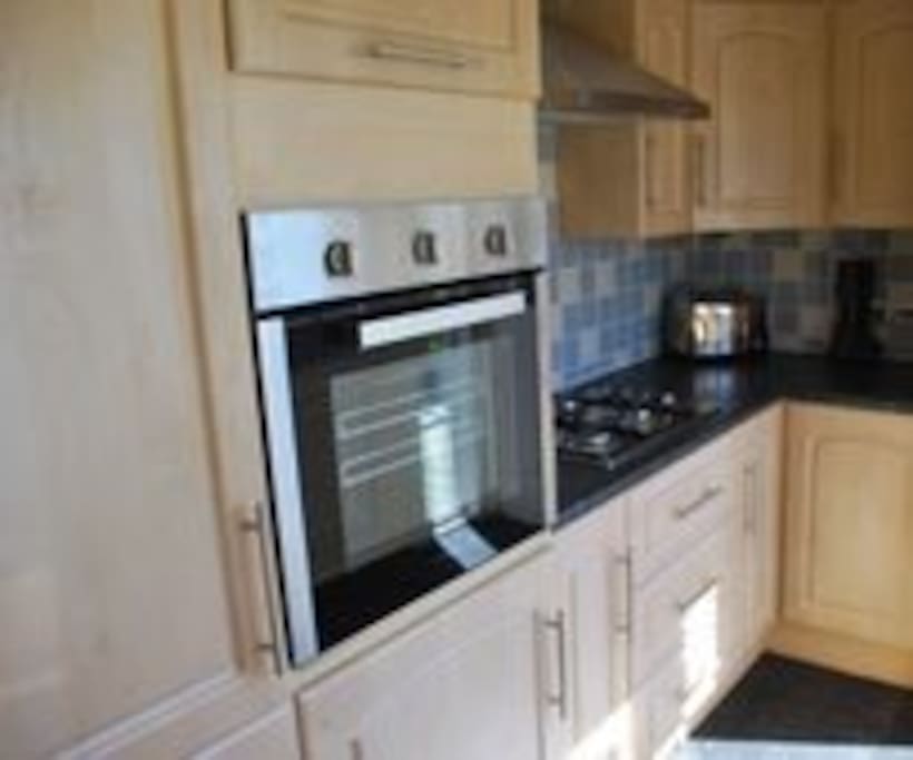 Kitchen full size fridge/freezer, cooker, hob, microwave, dishwasher.