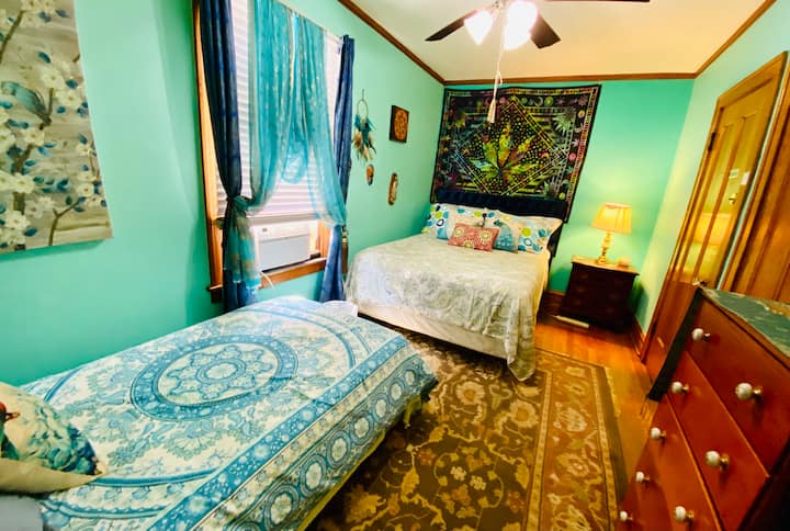 Spacious Master room with a queen size bed, a twin size bed, a dresser, closet, ceiling fan, lamps, AC., inside lock, etc.