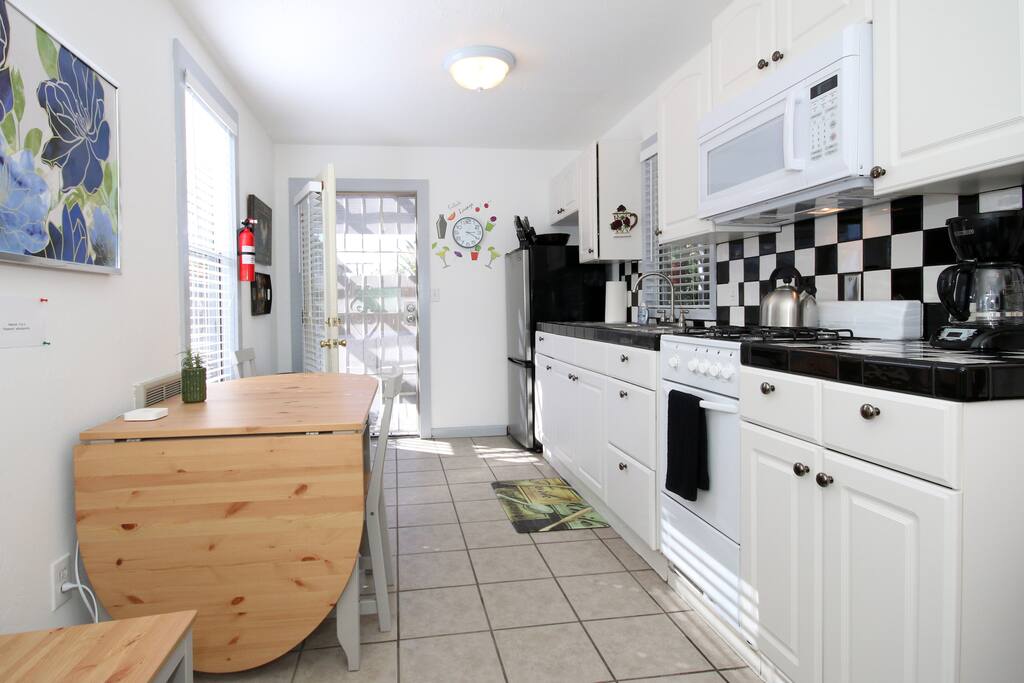 Kitchen and back door leading out to outside deck.