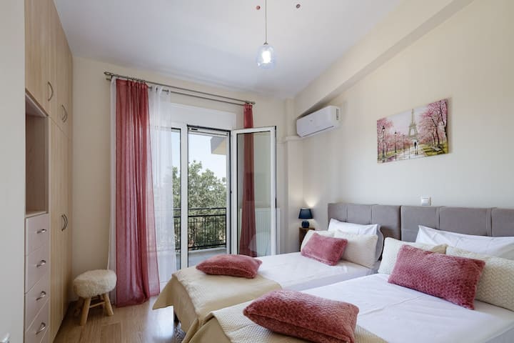 1st Floor | Bedroom 2 | A SMART TV 32" for entertainment with a seamless connection to the balcony, inviting the guests to enjoy the refreshing outdoor atmosphere.