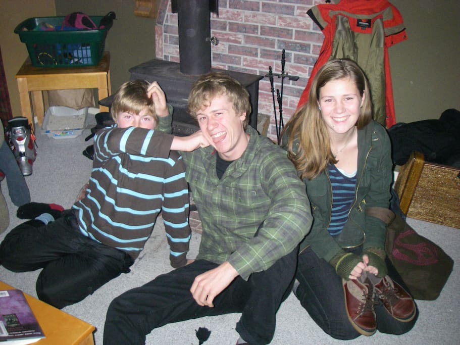 Kids staying warm by the wood stove