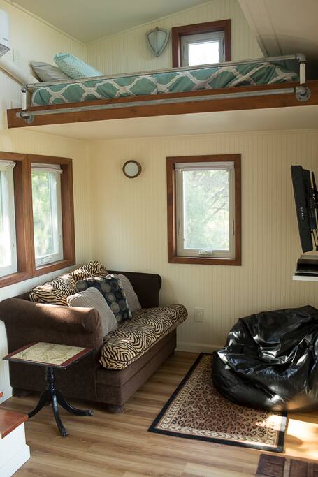 Living room of a Tiny House. Single sofa bed.