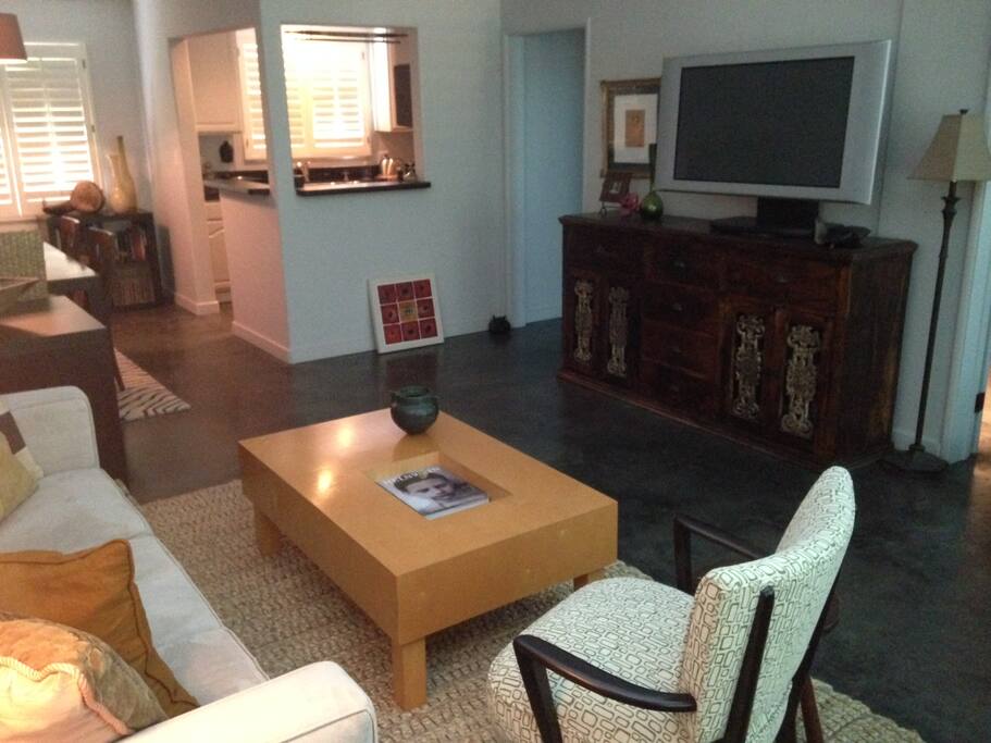 Living room area towards kitchen w/large tv, etc.