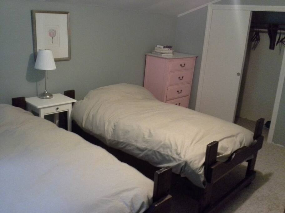 The twin beds of the Bushwacker Room, sitting side beside, with closet, night stands and dresser all available for use.