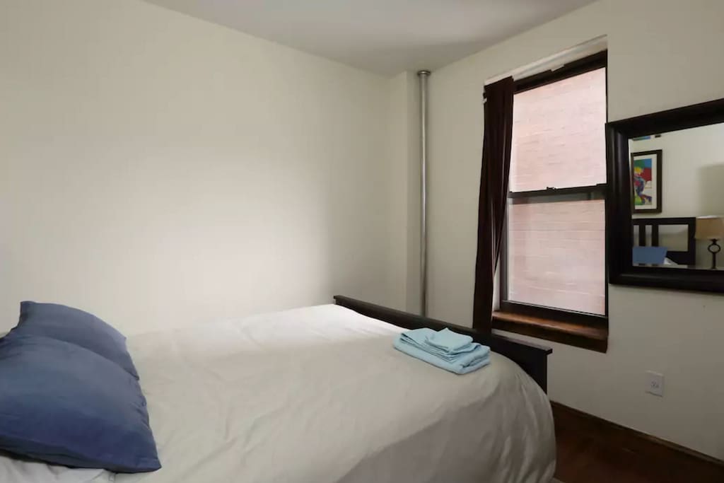 The bedroom has a queen sized bed, A/C, sunlight and plenty of closet space.