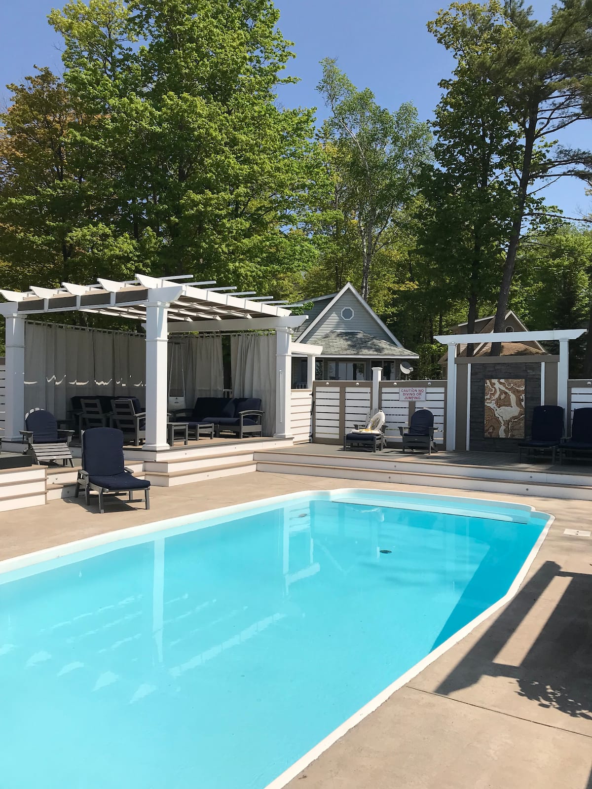 Pool with extensive lounge area and outdoor fireplace. A great place to spend an afternoon or evening!