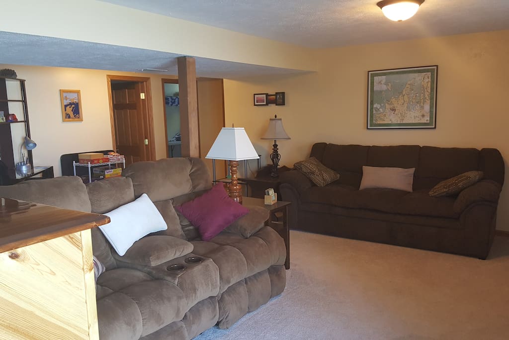 Living room includes a desk and a variety of games.