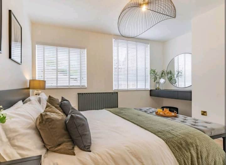 Gorgeous main bedroom complete with king-sized bed, dressing area and fitted wardrobes