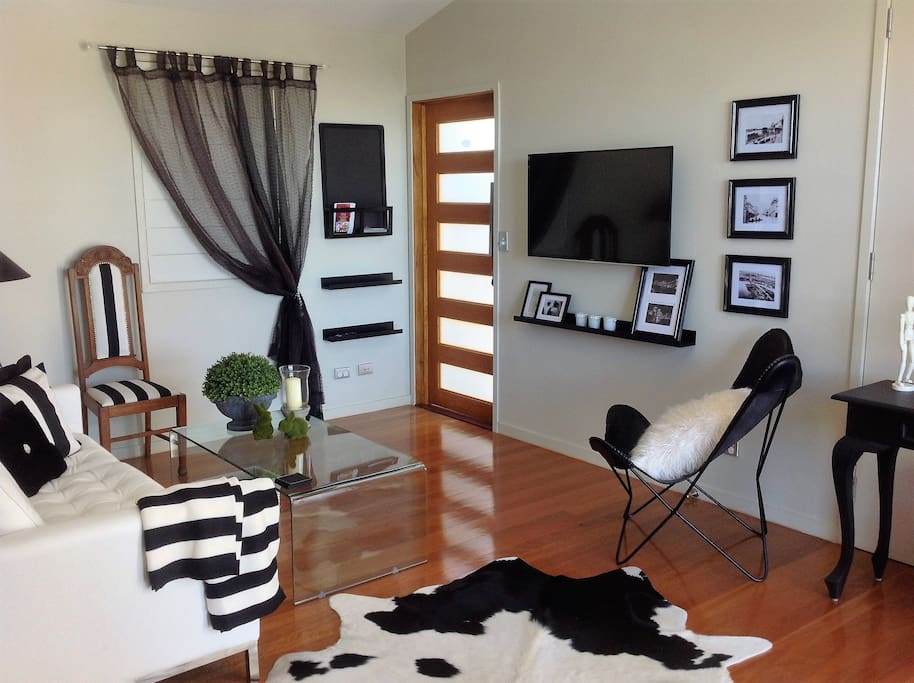 Front entrance and lounge with smart TV.