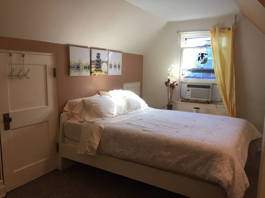 Queen size bed. Large sunny bedroom.