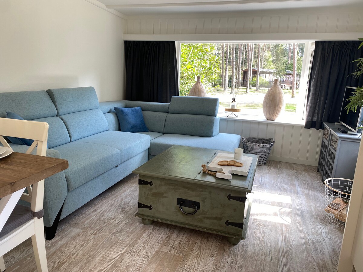 The living room has a spacious corner sofa that can also be used as a sofa bed to chill out. The right side of the corner sofa can also be used as a storage space. 