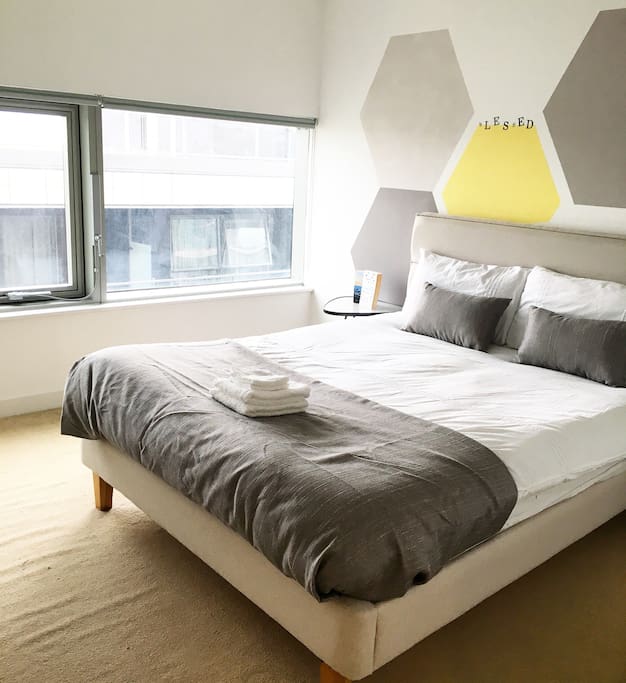 Contemporary master bedroom complete with clean and fresh sheets