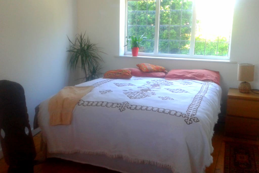 Lovely light, spacious bedroom with garden view.