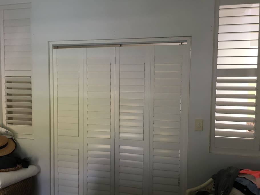 Airy new timber shutter windows n fold black doors. Privacy and air flow