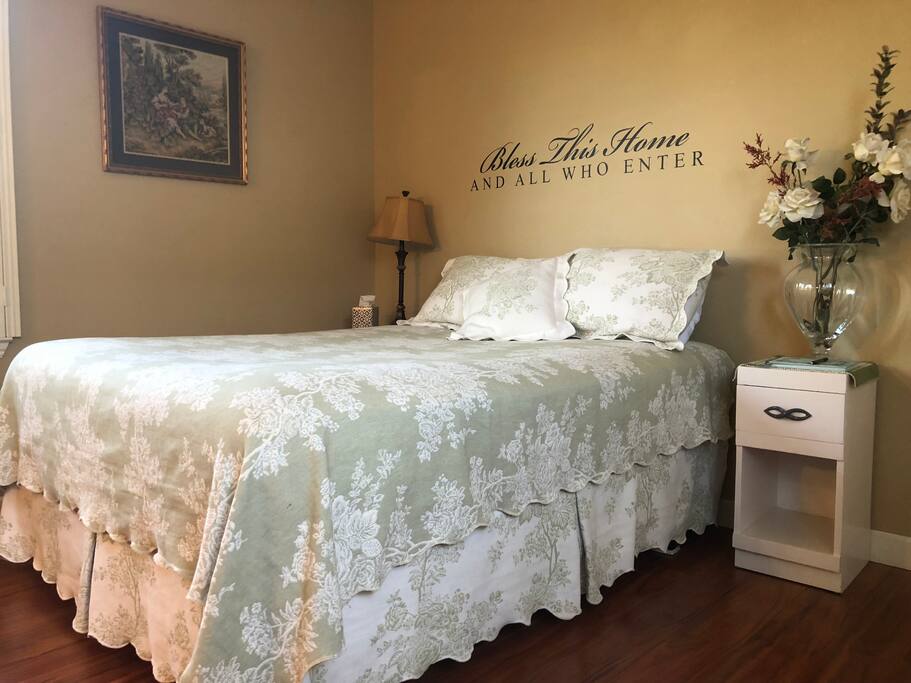 Queen sized bed with luxury sheets.
