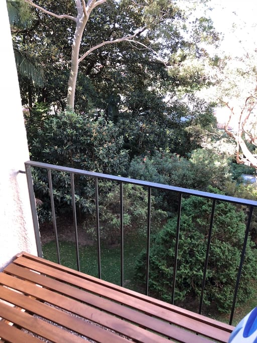 Balcony overlooks communal garden with lots of native birds
