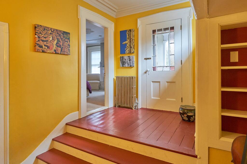 This is the view from the front door into the private foyer. The exterior door with original stained glass leads to a covered porch, the other to the bedroom.