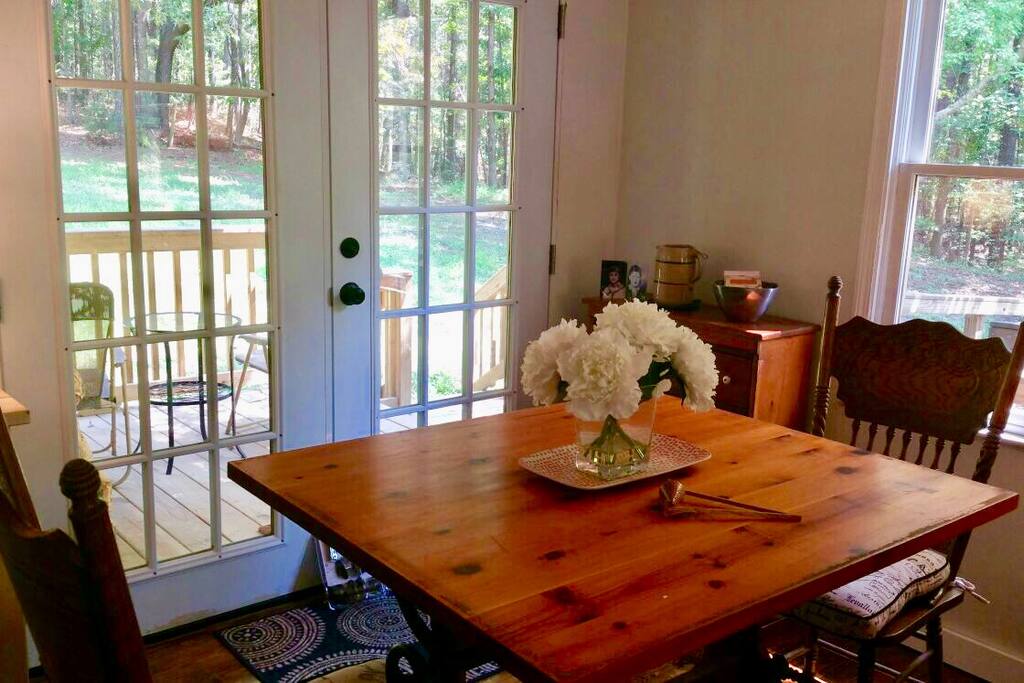 Dining area has view out to the back porch and back yard of the house.