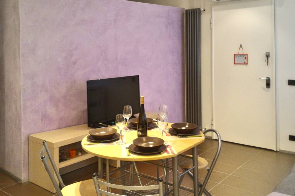 La zona giorno e tv led con tavolo da pranzo/ Living area with led tv and dining table