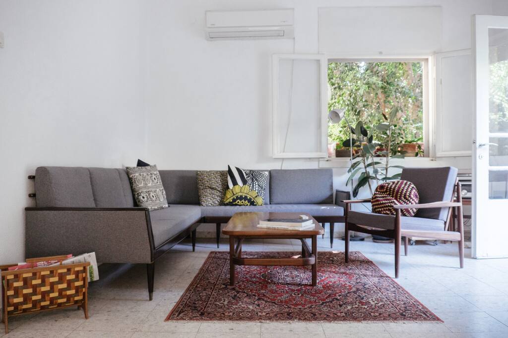 Our mid-century living room is attached to our balcony which means you get a cool afternoon breeze even on a hot summer day