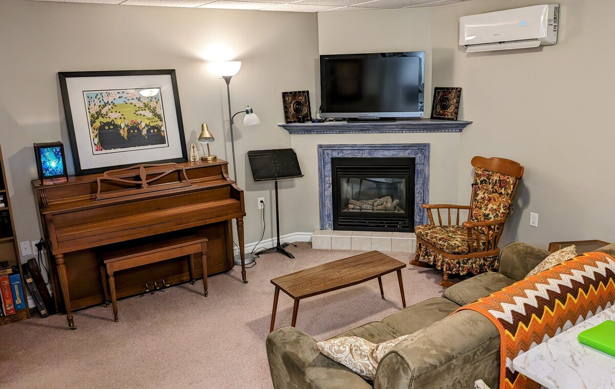 Living room with piano, mini split heat pump (provides heat and AC), gas fireplace, 42" TV with standard cable and Google Chromecast (bring your own Netflix etc accounts), books and board games.