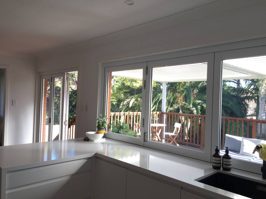 Bifold windows open up onto outdoor servery