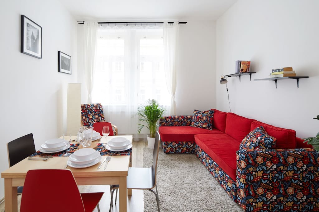 Our livig room - we have furnished it with wonderfully colourful folding sofa for two, folding dinner table for up to six a nice renovated rocking chair and charming pictures of Prague ;-)