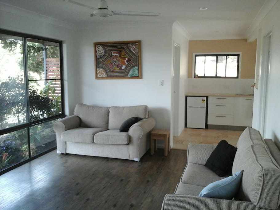 Light and airy lounge room looking out on deck and pool