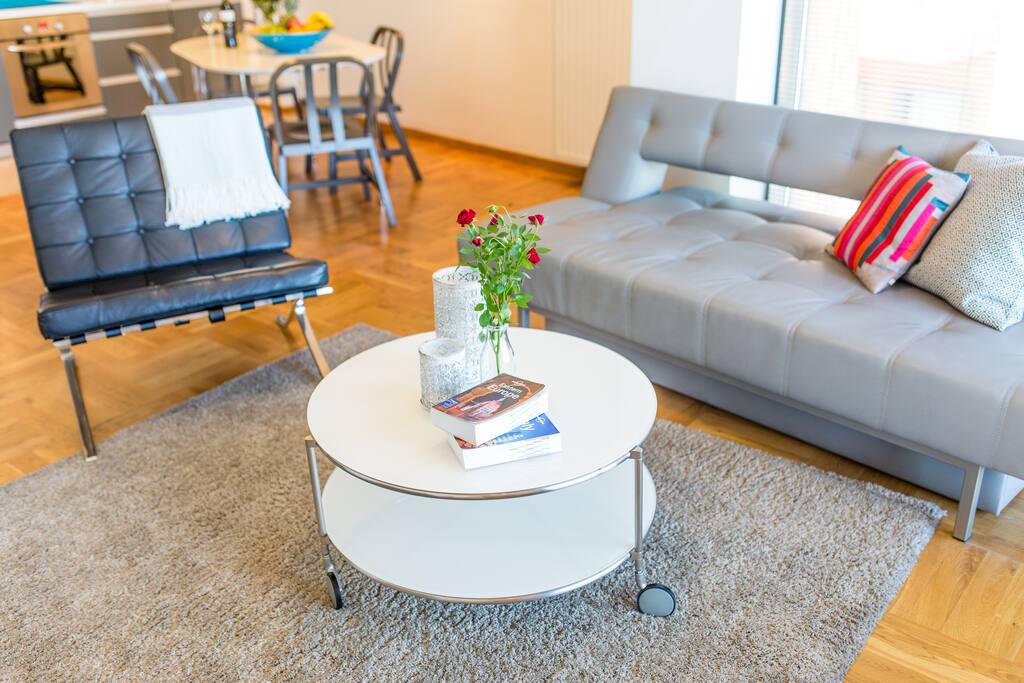 Living room with sofa, TV and balcony