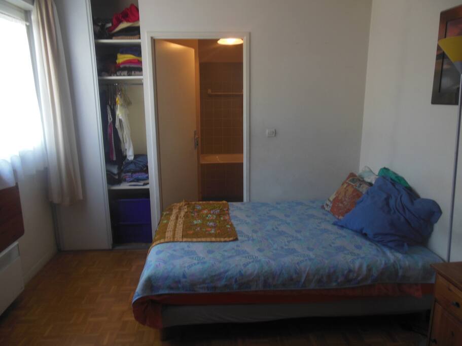 Chambre avec lit double. Au fond : la salle de bain