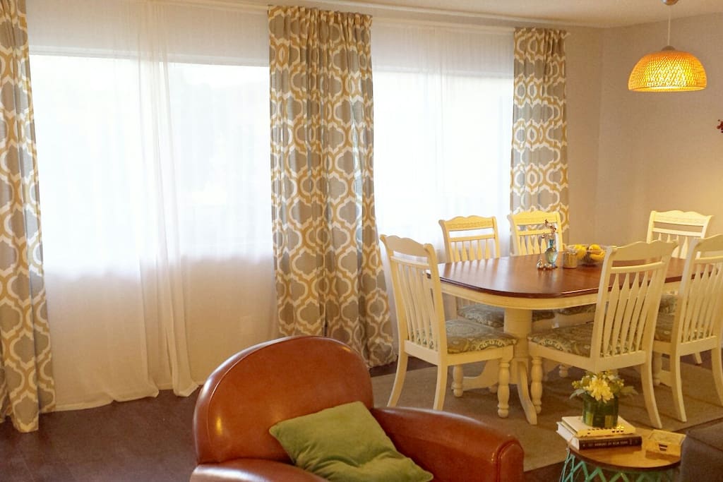 The spacious dining area has a large dining table that seats 6