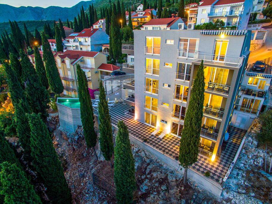 House exterior - apartment ground floor terrace on the right hand side behind the cypress